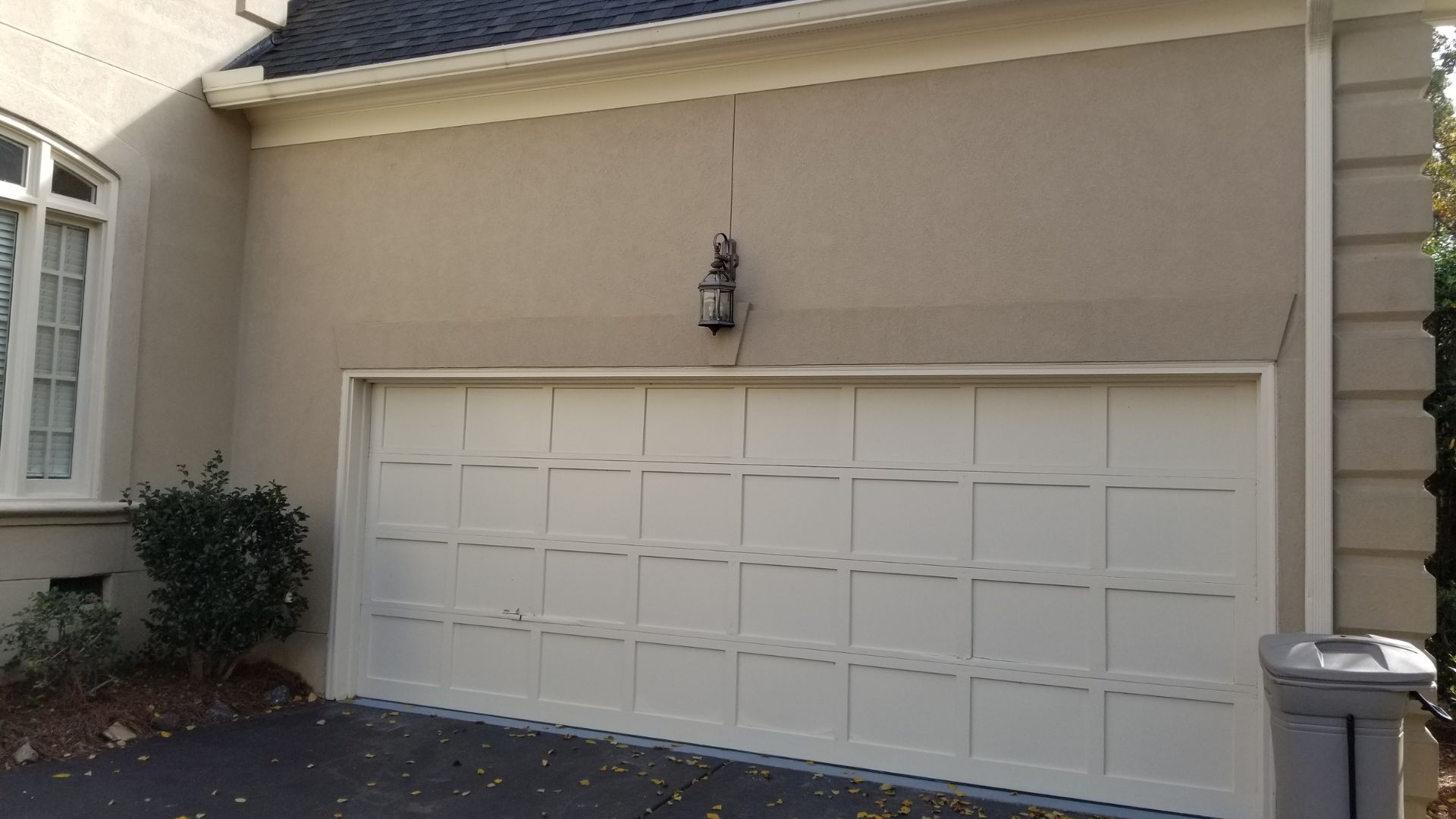 Residential garage door on a Charlotte-area home, the kind of door covered by a seasonal maintenance routine
