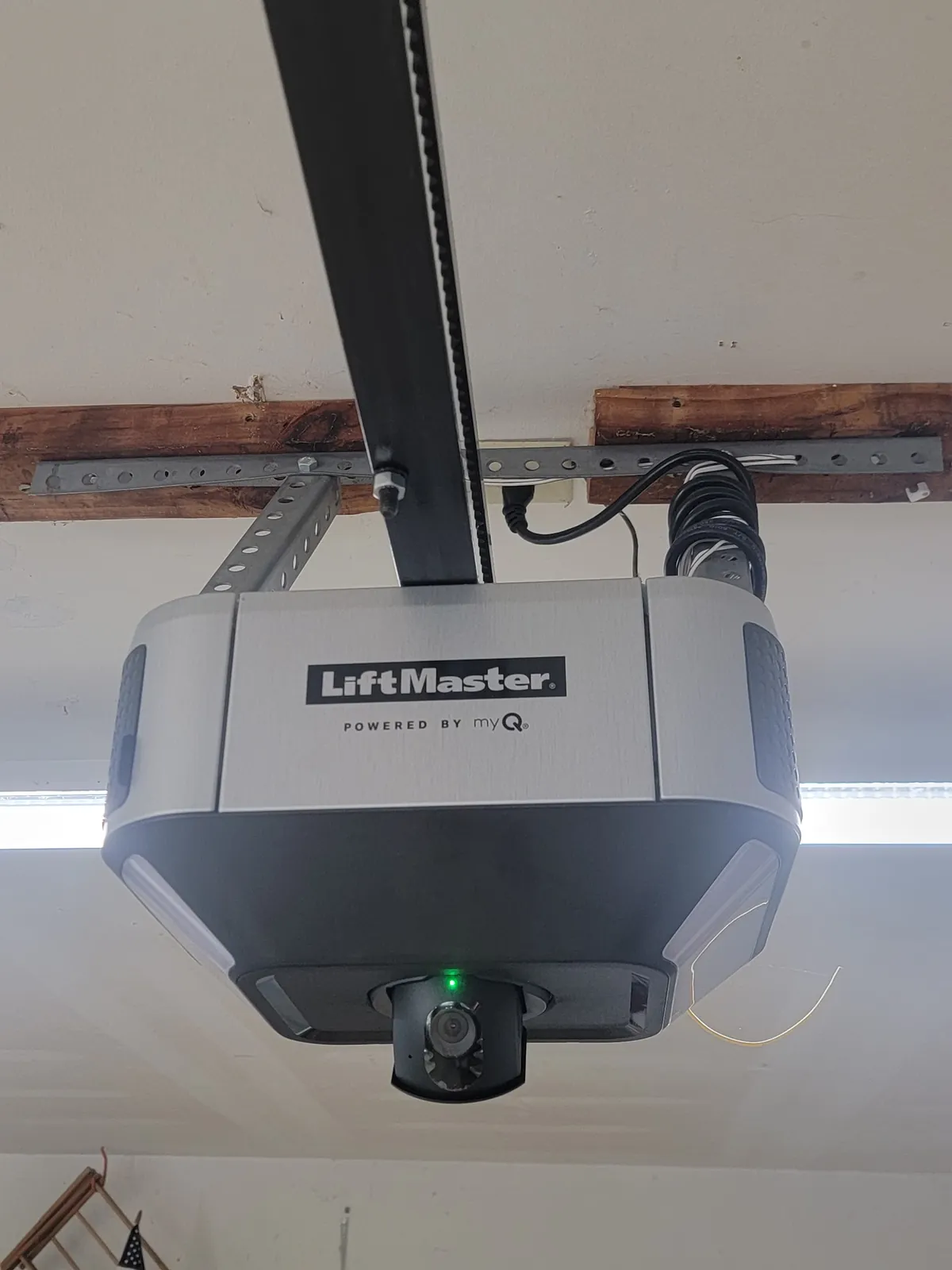 LiftMaster garage door opener installed on a garage ceiling